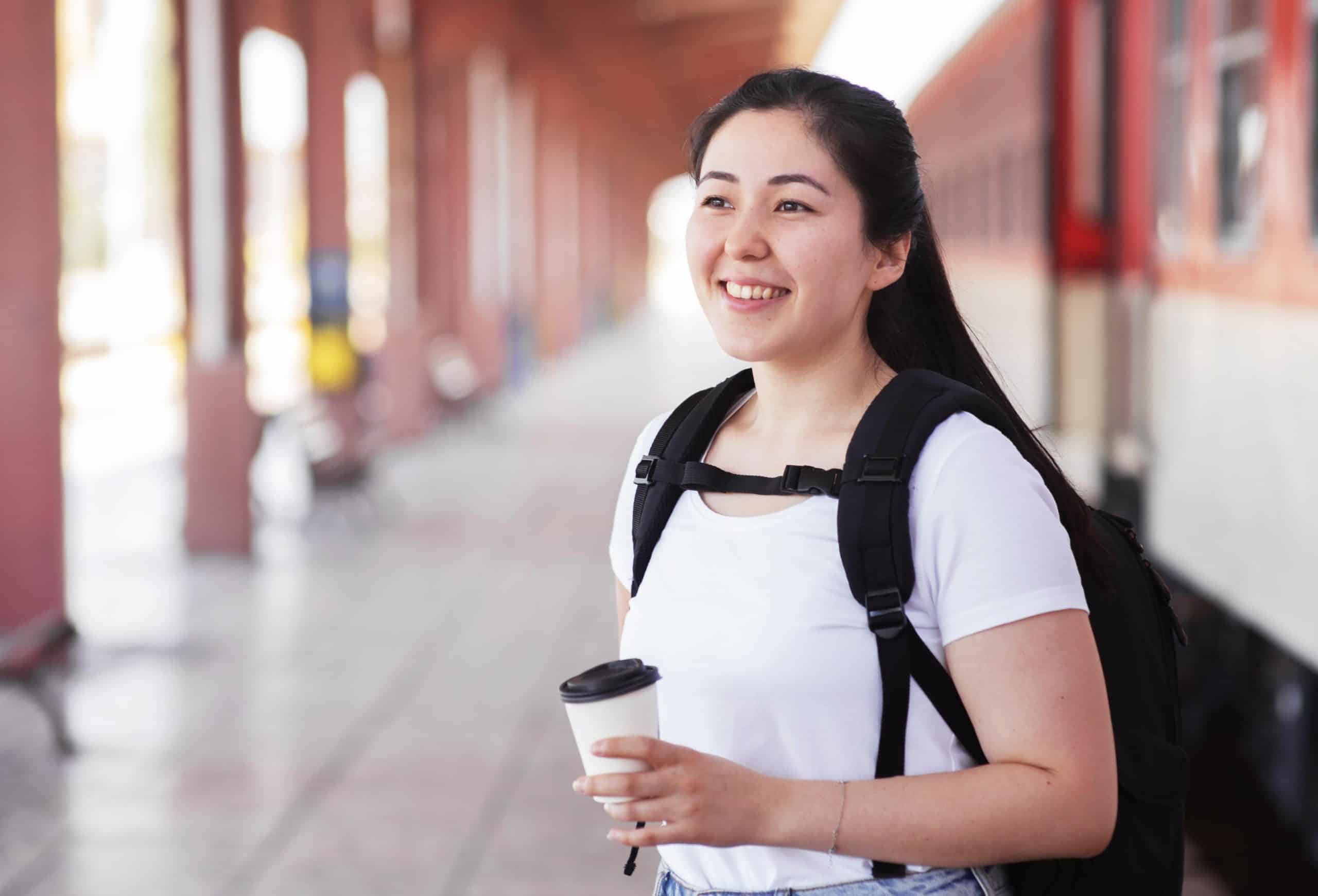side-view-smiley-woman-train-station-scaled